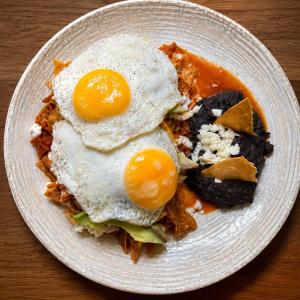 a plate of food with eggs on a table at Hotel Jar8 Bule Frente al Mar in Boca del Río