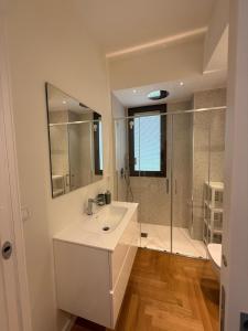 a white bathroom with a sink and a shower at La Fenice in Citta' Sant'Angelo +40 photos