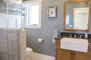 a bathroom with a sink and a toilet and a mirror at Playa One Bedroom (251) in Carpinteria +2 photos