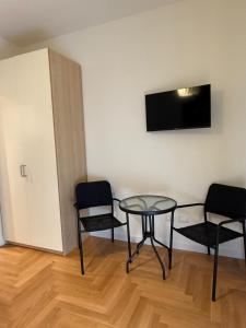 a room with two chairs and a table and a television at La Fenice in Citta' Sant'Angelo