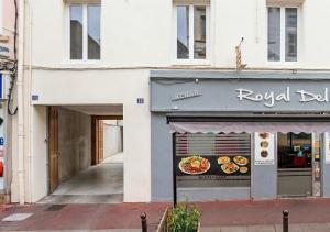 a restaurant with a sign on the side of a building at L'Opale in Roanne