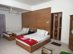 a hotel room with two beds in a room at HOTEL AL SAFA INTERNATIONAL, Ashkona in Dhaka