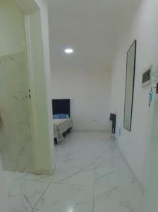 a white room with a bed and a mirror at CENTENO CASI 9 DE JULIO in Santa Rosa