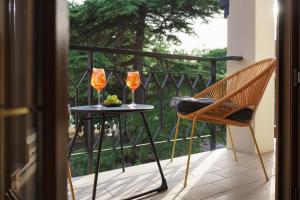 a balcony with a table and two wine glasses at Appartamento Nel Sole in Passignano sul Trasimeno