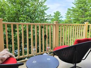 a patio with two chairs and two wine glasses at Tremblant Prestige - BONDURANT 95-10 in Mont-Tremblant