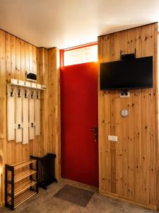 a room with a red door and a wall with baseball bats at Trio Villas Retreat in Grigoleti