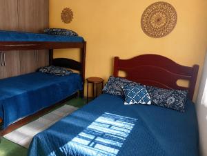 a bedroom with two bunk beds and blue sheets at Recanto Seu Luis Piscina,Represa e caiaques in Ibiúna +57 photos