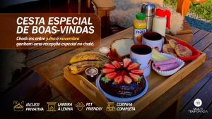 a wooden table with a tray of food on it at Chalé Caminho do Sol in Rancho Queimado