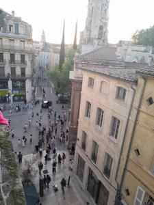a crowd of people walking down a city street at Chambre Palais des Papes Avignon in Avignon +3 photos