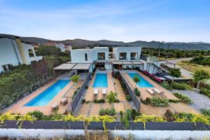 an aerial view of a house with two swimming pools at Saronia Estate in Galatákion