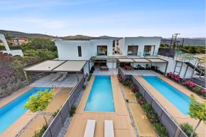 an aerial view of a house with two swimming pools at Saronia Estate in Galatákion