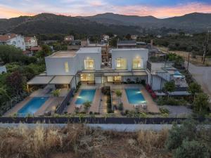 an aerial view of a house with two swimming pools at Saronia Estate in Galatákion +113 photos