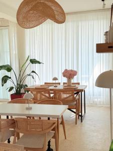 a dining room with tables and chairs and plants at LIMANI in Grigoleti