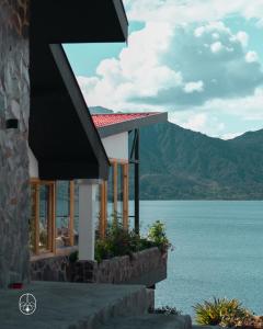 a house with a view of a body of water at Ecohotel Mauka in Pasto