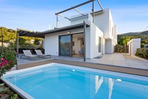 a villa with a swimming pool and a house at Saronia Estate in Galatákion