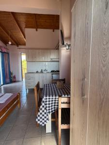 a kitchen with a table with a checkered table cloth at Ilios Kalamaki in Kalamaki