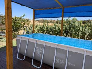 a hot tub on a deck with cacti at Moonlight Suite Arad צימר אור הירח, ערד in Arad