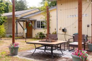 a picnic table in front of a house at Coastal Studio in Brookings