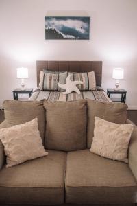 a bedroom with a bed and a couch with pillows at Coastal Studio in Brookings