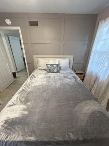 a bedroom with a large bed with a pillow on it at Robin's Nest Savannah in Savannah +32 photos