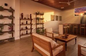 a living room with a couch and a table at Fitzcarrald Hotel in Iquitos