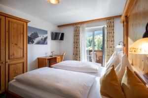 a hotel room with two beds and a window at Gasthof Aschenwald in Westendorf +66 photos