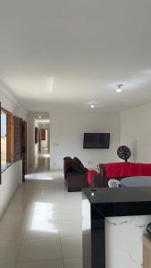 a living room with a couch and a table at Villa Serrinha - Sitio Paraiso in Serrinha