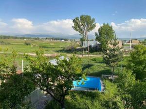 an overhead view of a swimming pool in a field at Gariks house in Lichkʼ