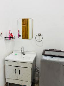 a bathroom with a sink and a mirror at Sadhana kunj in Varanasi +21 photos
