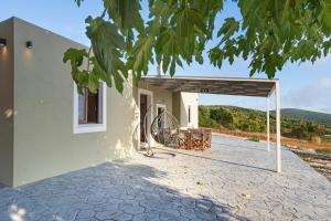 a porch of a house with a swing at Mulberry Tree House in Póndi