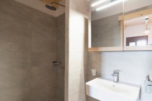 a bathroom with a sink and a shower at Mulberry Tree House in Póndi +17 photos