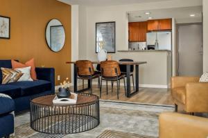a living room with a couch and a table at Urban Gallery Loft - King Bed - Larimer Square in Denver