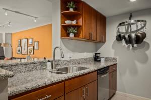 a kitchen with a sink and a counter top at Urban Gallery Loft - King Bed - Larimer Square in Denver