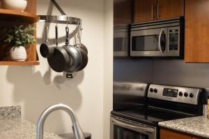 a kitchen with a stove and a microwave at Urban Gallery Loft - King Bed - Larimer Square in Denver +47 photos
