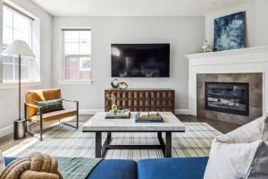 a living room with a blue couch and a fireplace at Modern Elegance - Pool Table - Walkable Area in Aurora