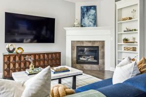 a living room with a blue couch and a fireplace at Modern Elegance - Pool Table - Walkable Area in Aurora +39 photos
