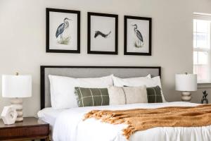 a bedroom with four pictures of birds on the wall at Modern Elegance - Pool Table - Walkable Area in Aurora