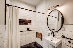 a white bathroom with a sink and a mirror at Modern ADA-Accessible Studio - Tennyson St Escape in Denver