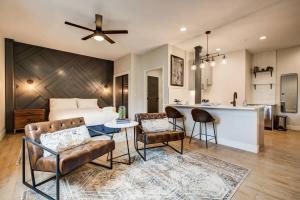 a living room with a couch and a table and a kitchen at Modern ADA-Accessible Studio - Tennyson St Escape in Denver