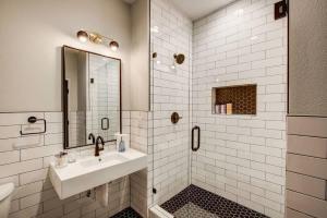 a white bathroom with a sink and a shower at Walkable Urban Tennyson St Apt - Steps to Eats in Denver