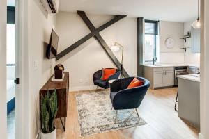 a living room with two chairs and a table at Walkable Urban Tennyson St Apt - Steps to Eats in Denver +5 photos
