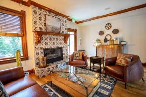 a living room with leather furniture and a fireplace at Pinky's Palace - Curtis Park Club - RiNo in Denver