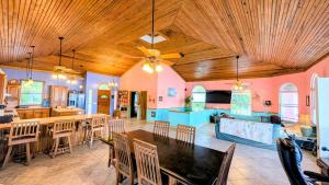 a large living room with a table and a kitchen at El Palacio Rosa, The Resort in Punta Gorda