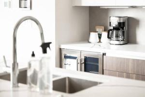 a kitchen with a sink and a coffee maker at Contemporary Condo - Grill - Balcony - Tesoro in Denver