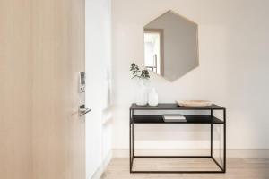 a table with a mirror next to a door at Contemporary Condo - Grill - Balcony - Tesoro in Denver +29 photos