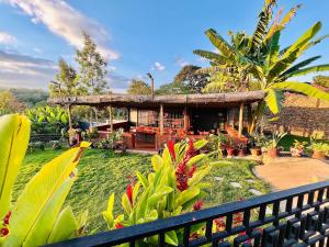 a house with a fence in front of it with plants at Stargate Apartments in Arusha