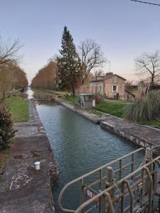 a canal of water with a boat in it at Halte à Ecluse d'Hôte in Calonges