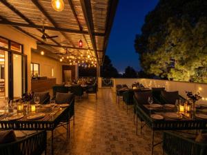 a dining room with tables and chairs and lights at Hotel Central Park Inn, in Dehradun
