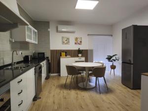 a kitchen with a table and chairs in it at Flor de Charme in Campo Maior