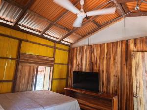 a bedroom with a bed and a ceiling fan at Parque Indigo Nature Lodge, Rincón de la Vieja in Liberia +21 photos